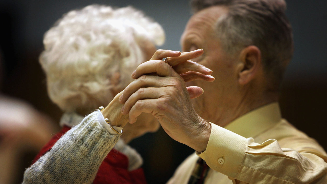 Boomers senior citizens, elderly couple, holding hands, dancing